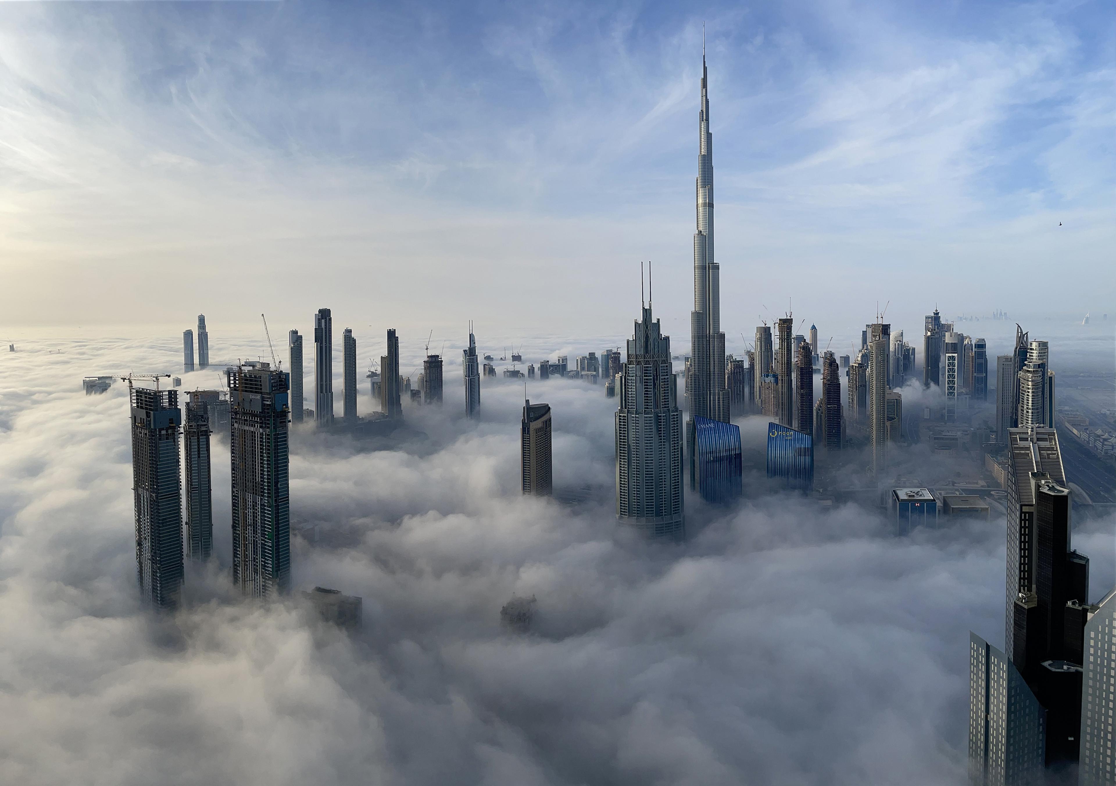 Skyline of Dubai with Skyscrapers peaking through the clouds