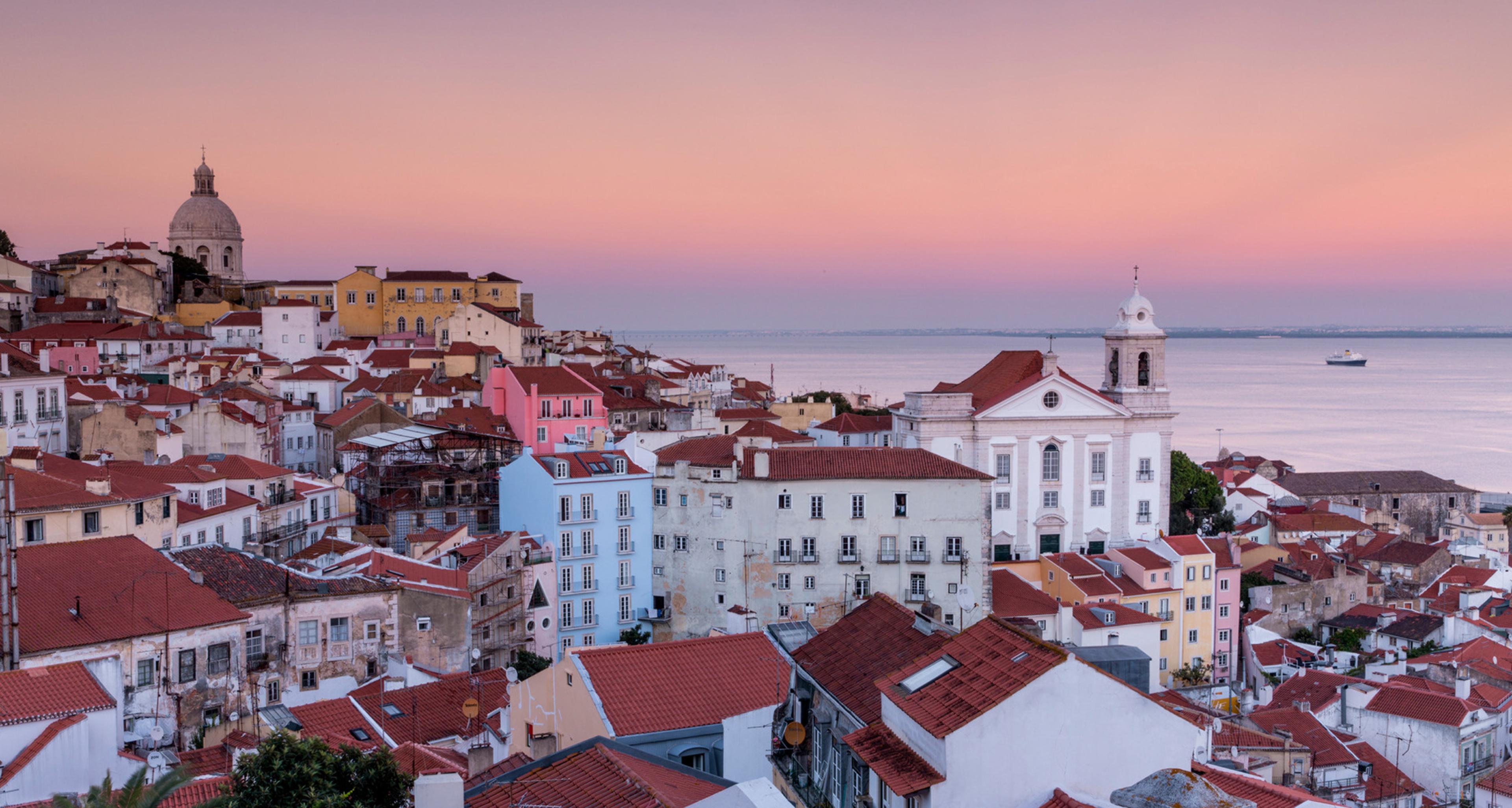 sunset over a city with red roofs