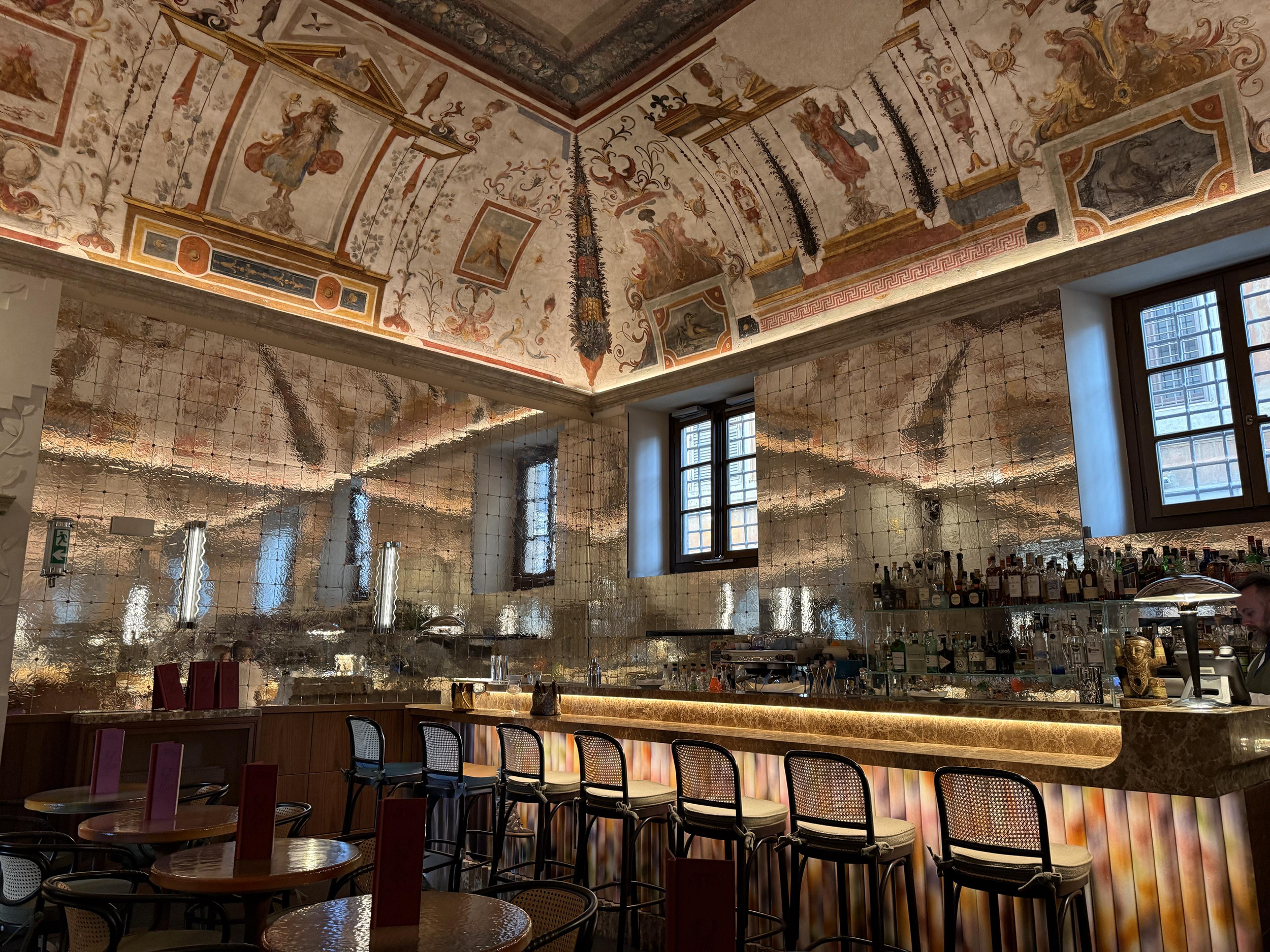 ornate cocktail bar with frescoed ceilings