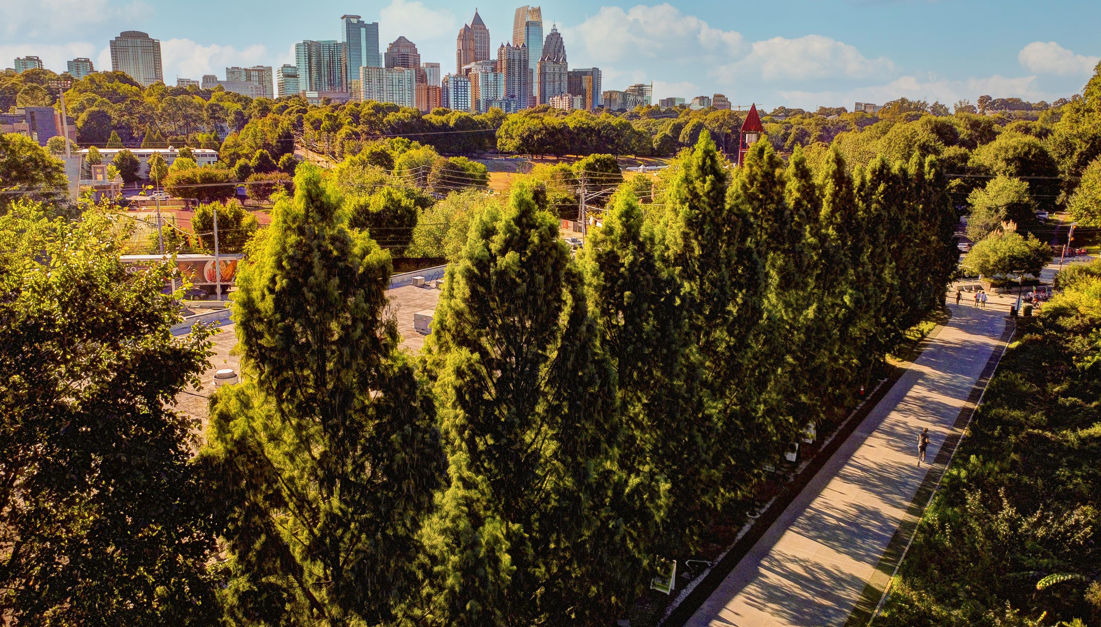 aerial view over park bike path with atlanta skyline in distance