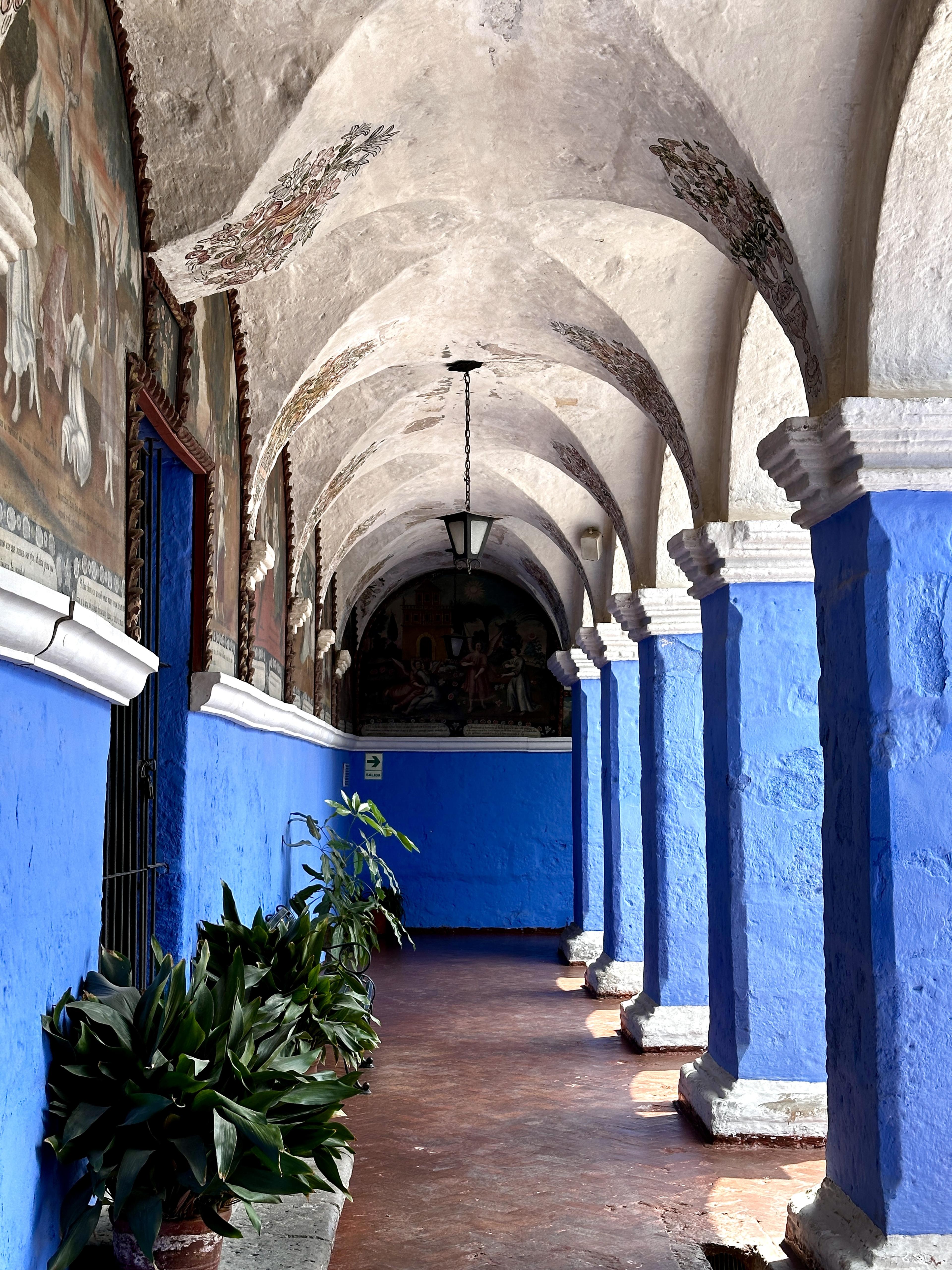 line of blue columns in a stone gallery