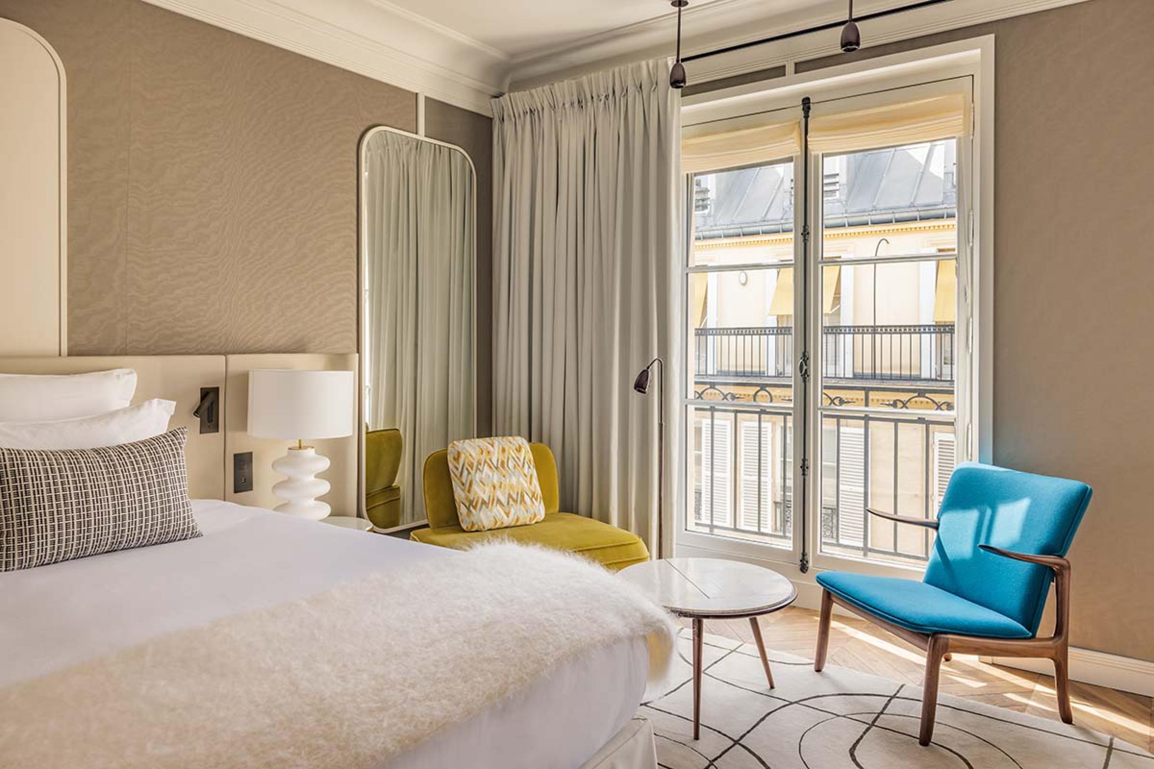 bedroom with a white bed and blue chair