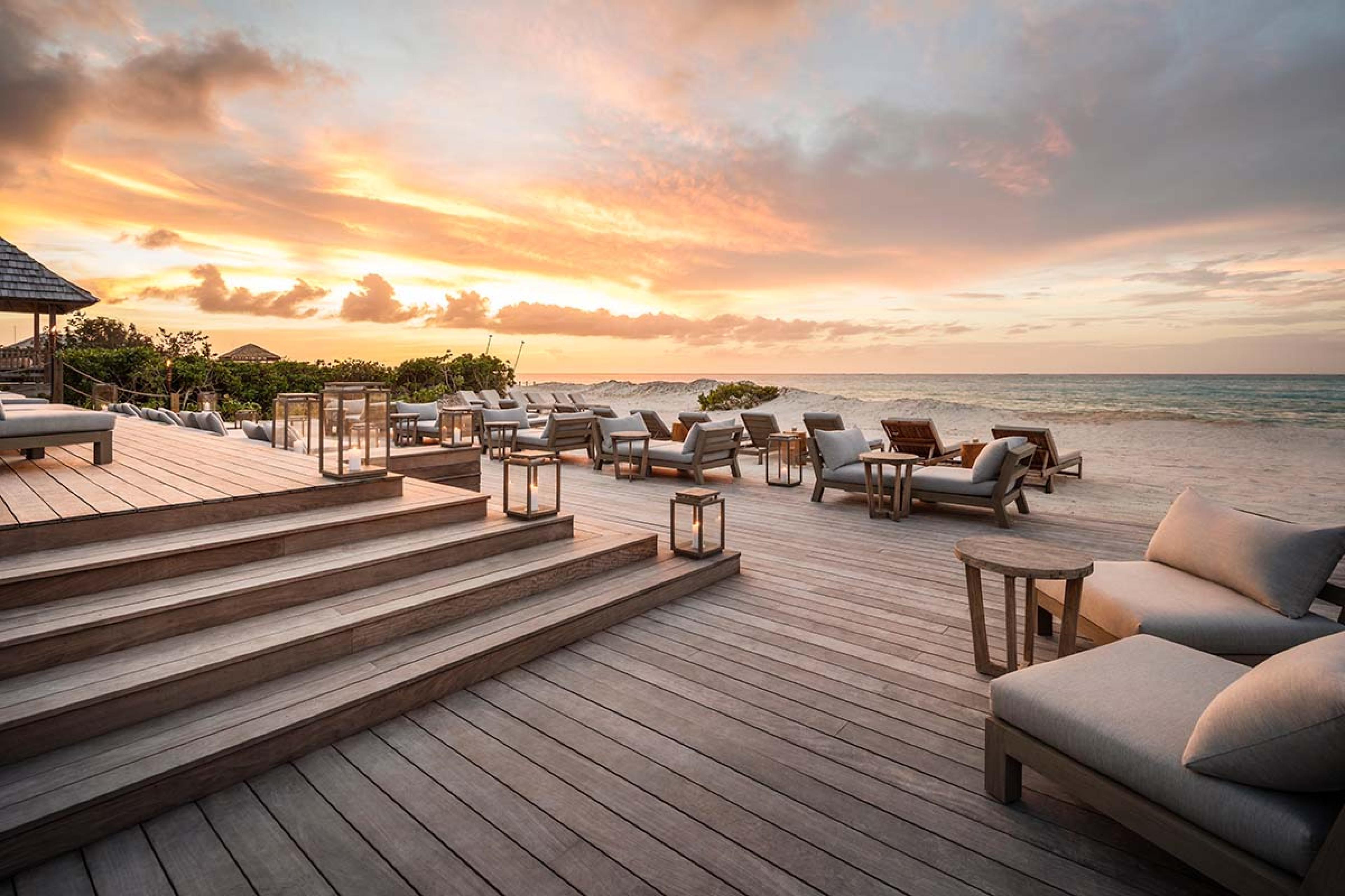 patio with lounge chairs by the beach