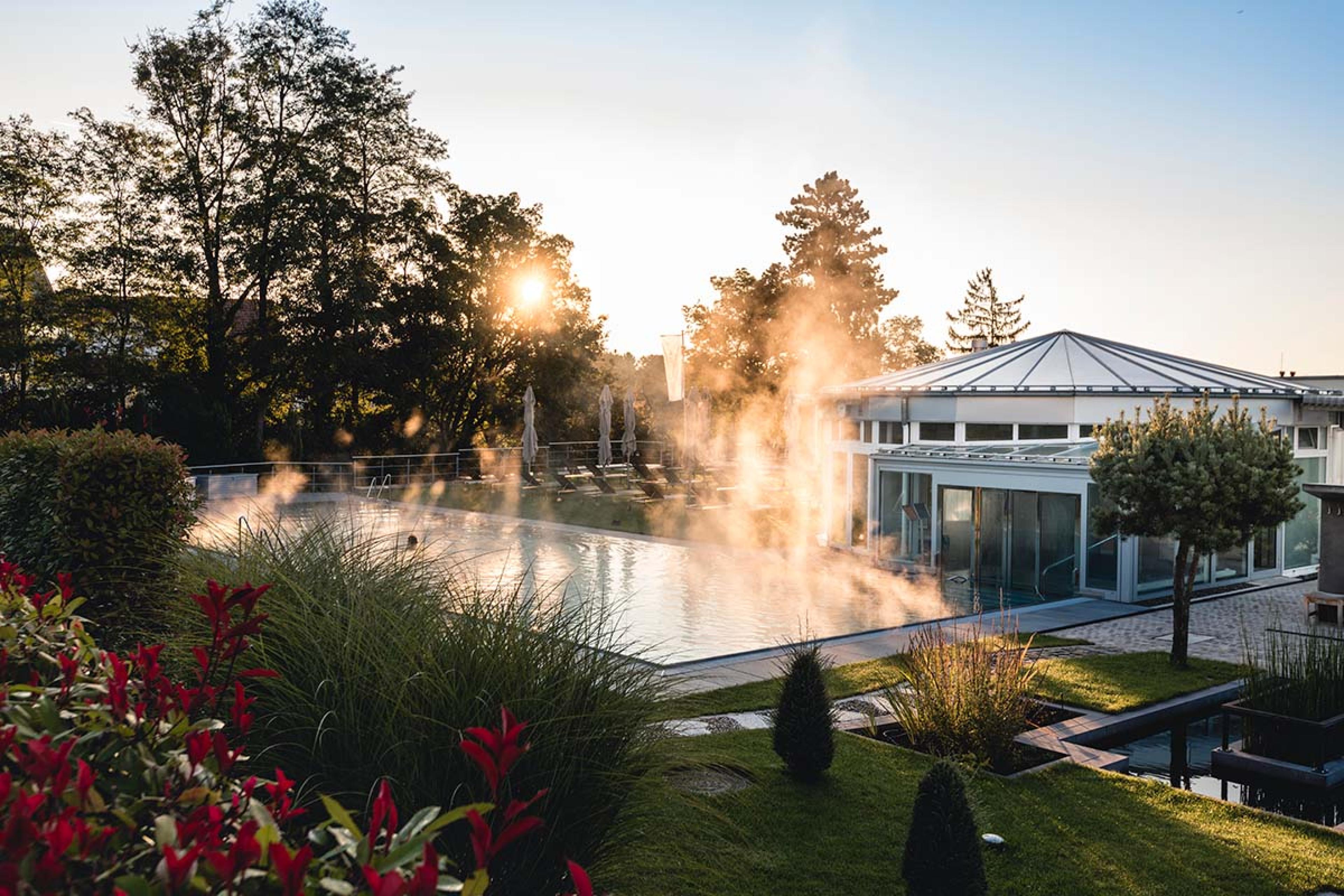 heated pool with grass around it