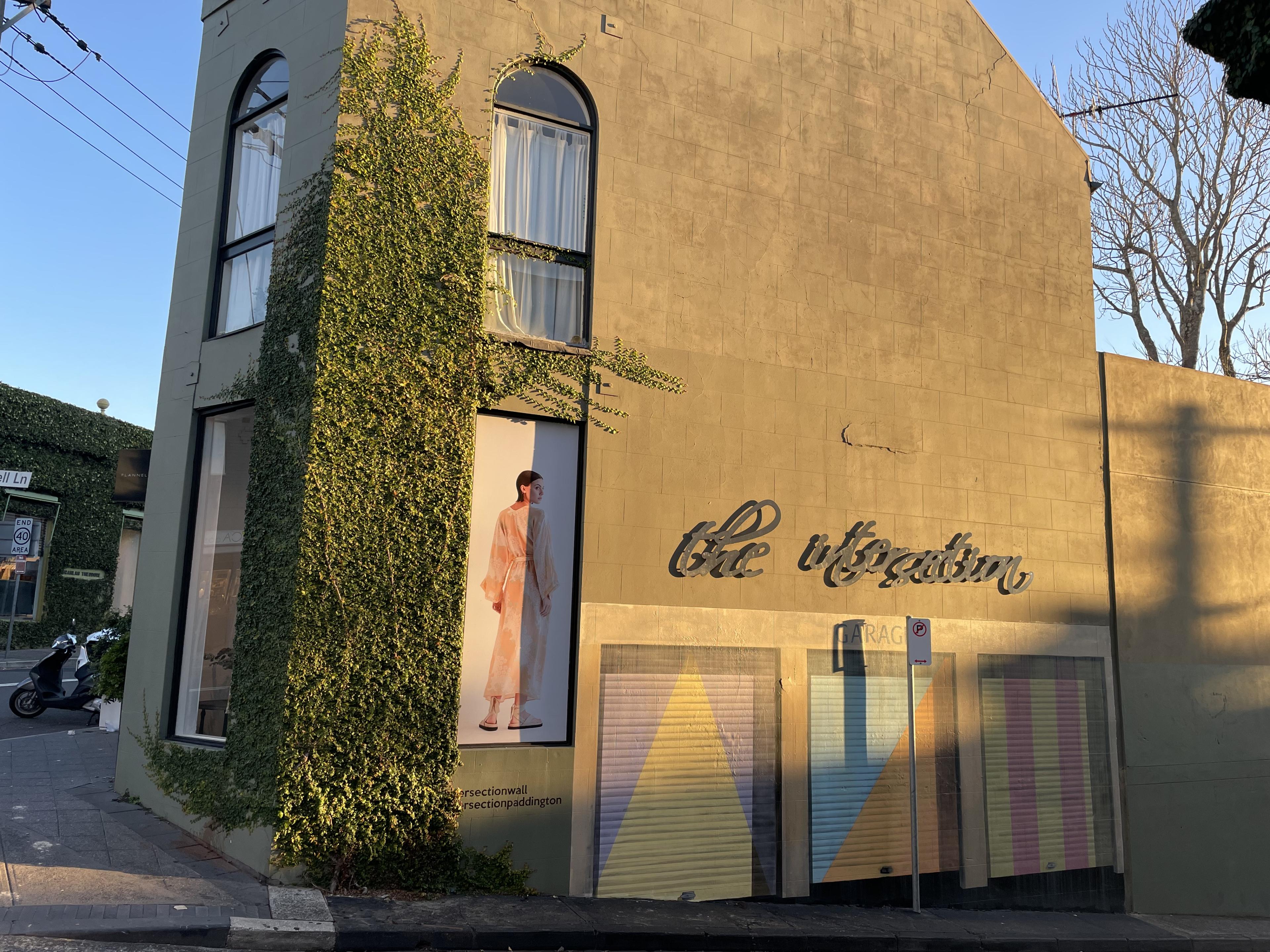 exterior of building with cursive sign saying "the intersection"