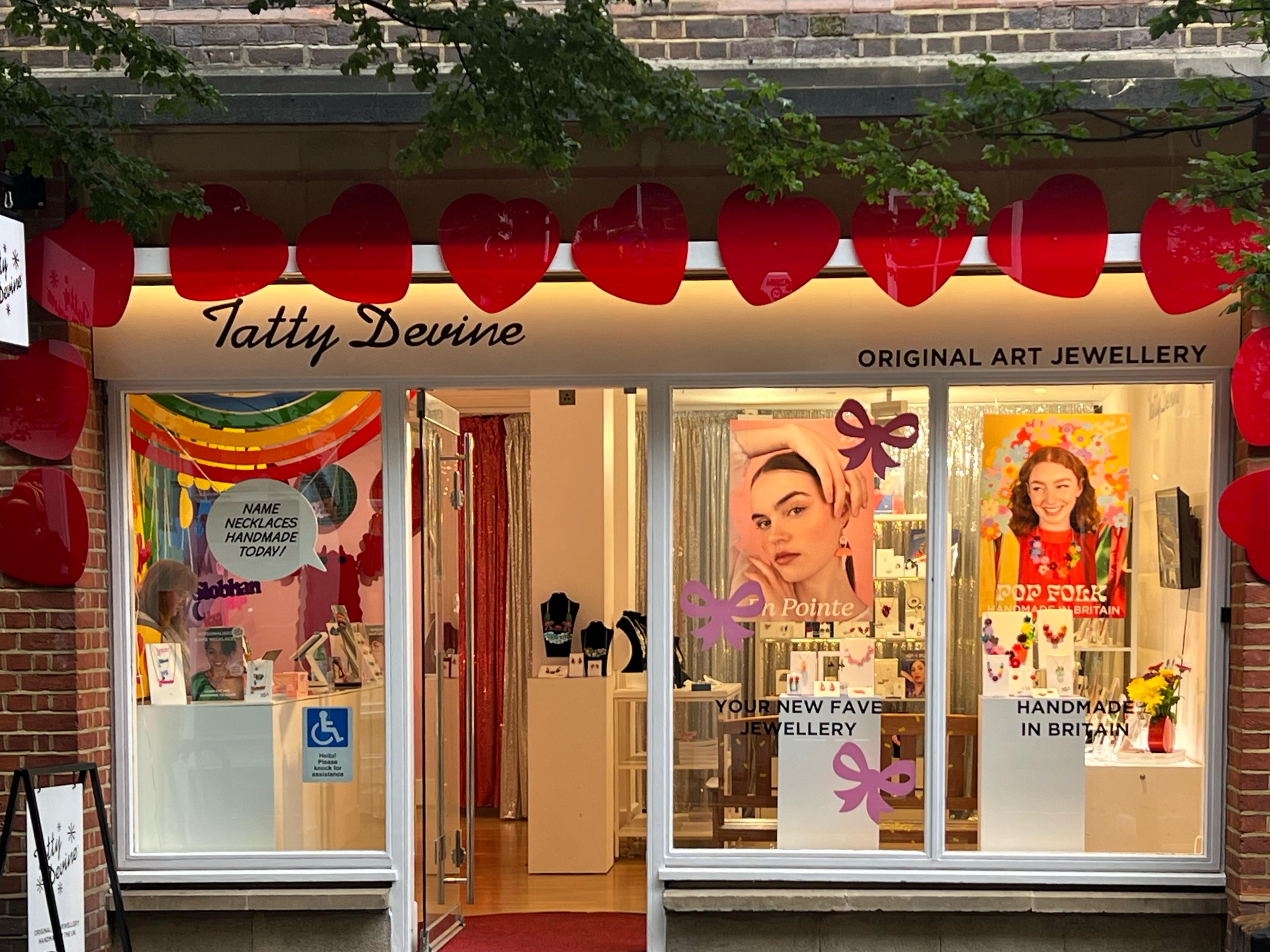 store window saying tatty devine in cursive on top left 