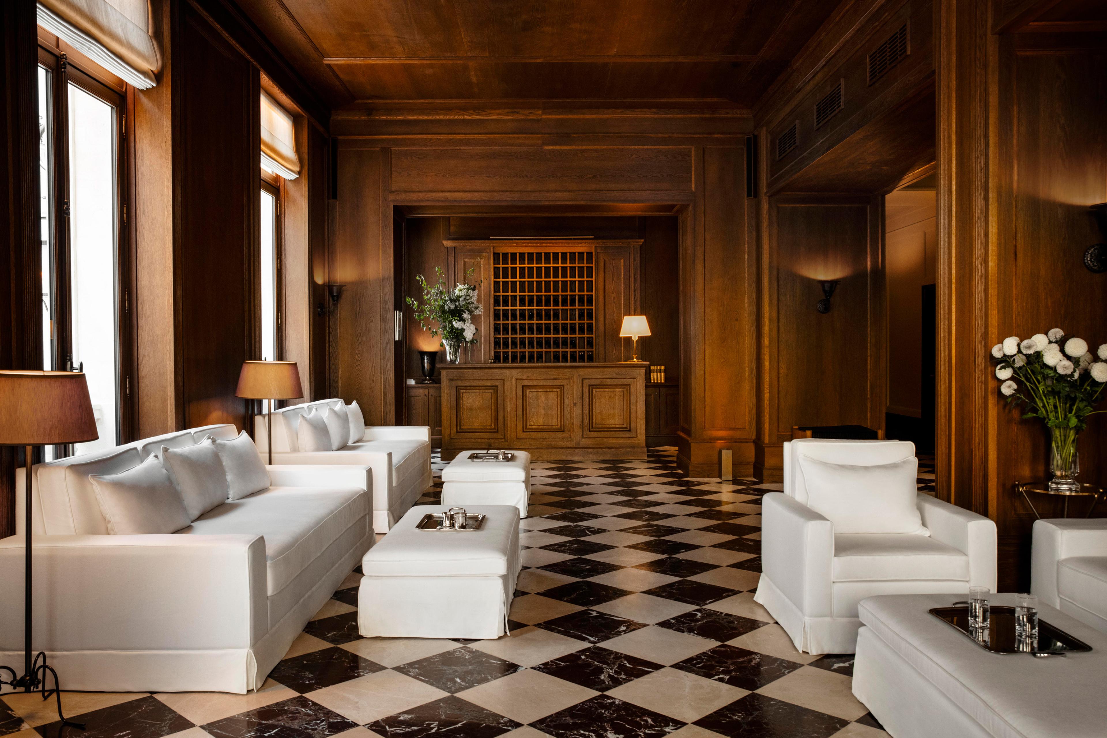 lobby with black and white tiled floors and white seating