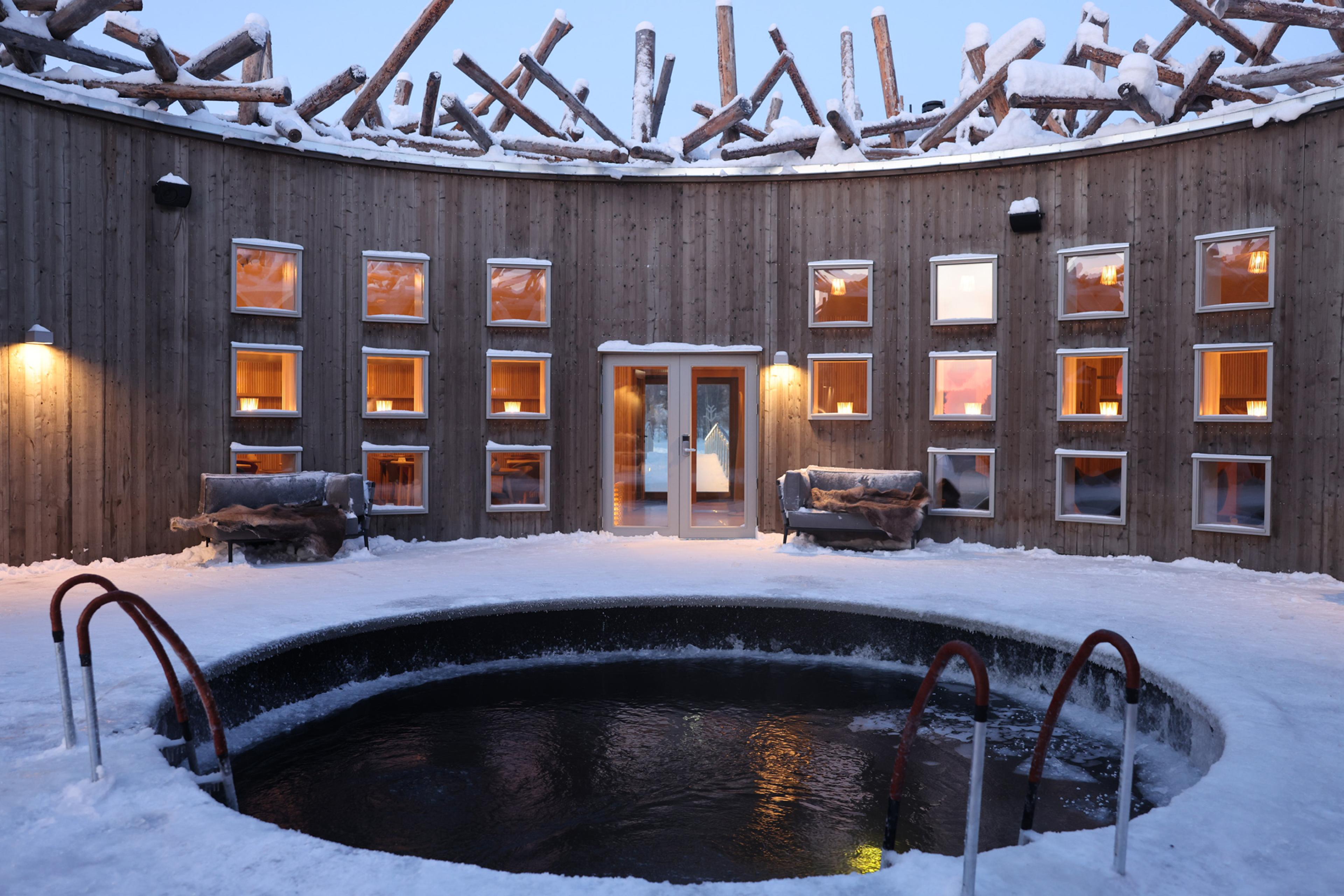 round plunge pool in the center of a circular building in the winter