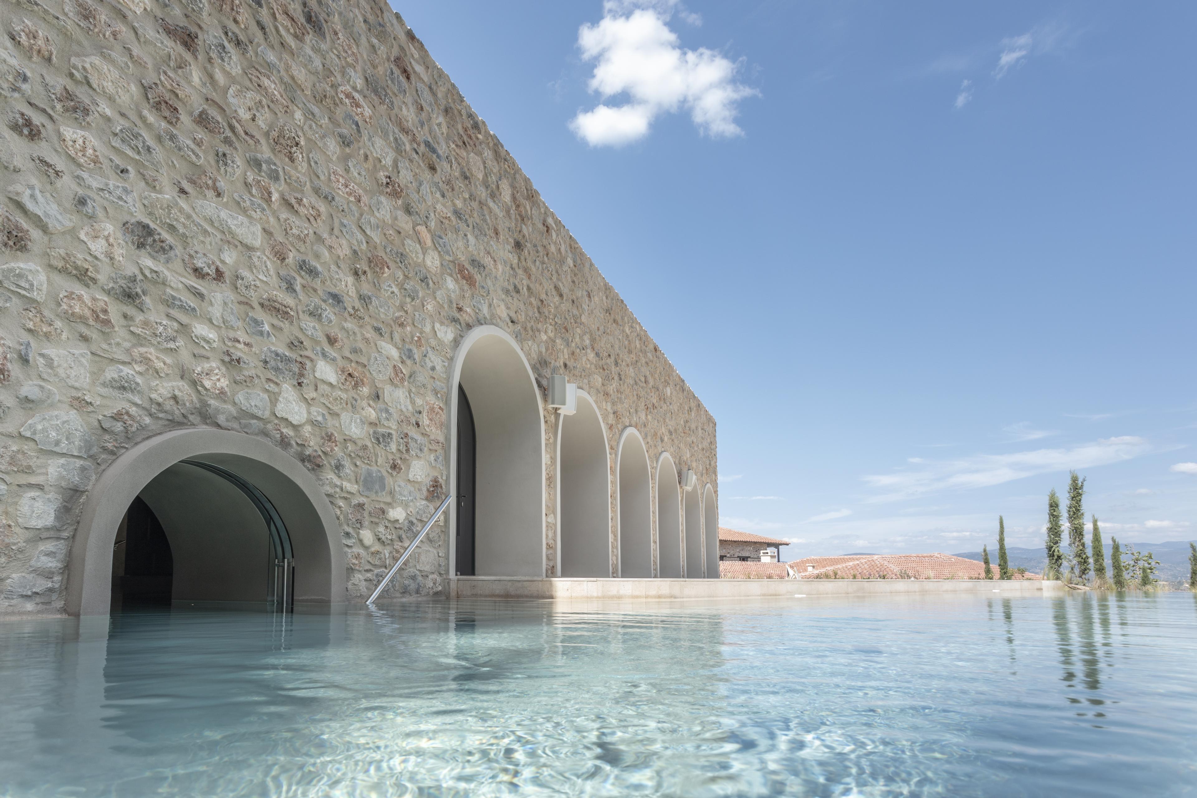 outdoor pool next to stone building
