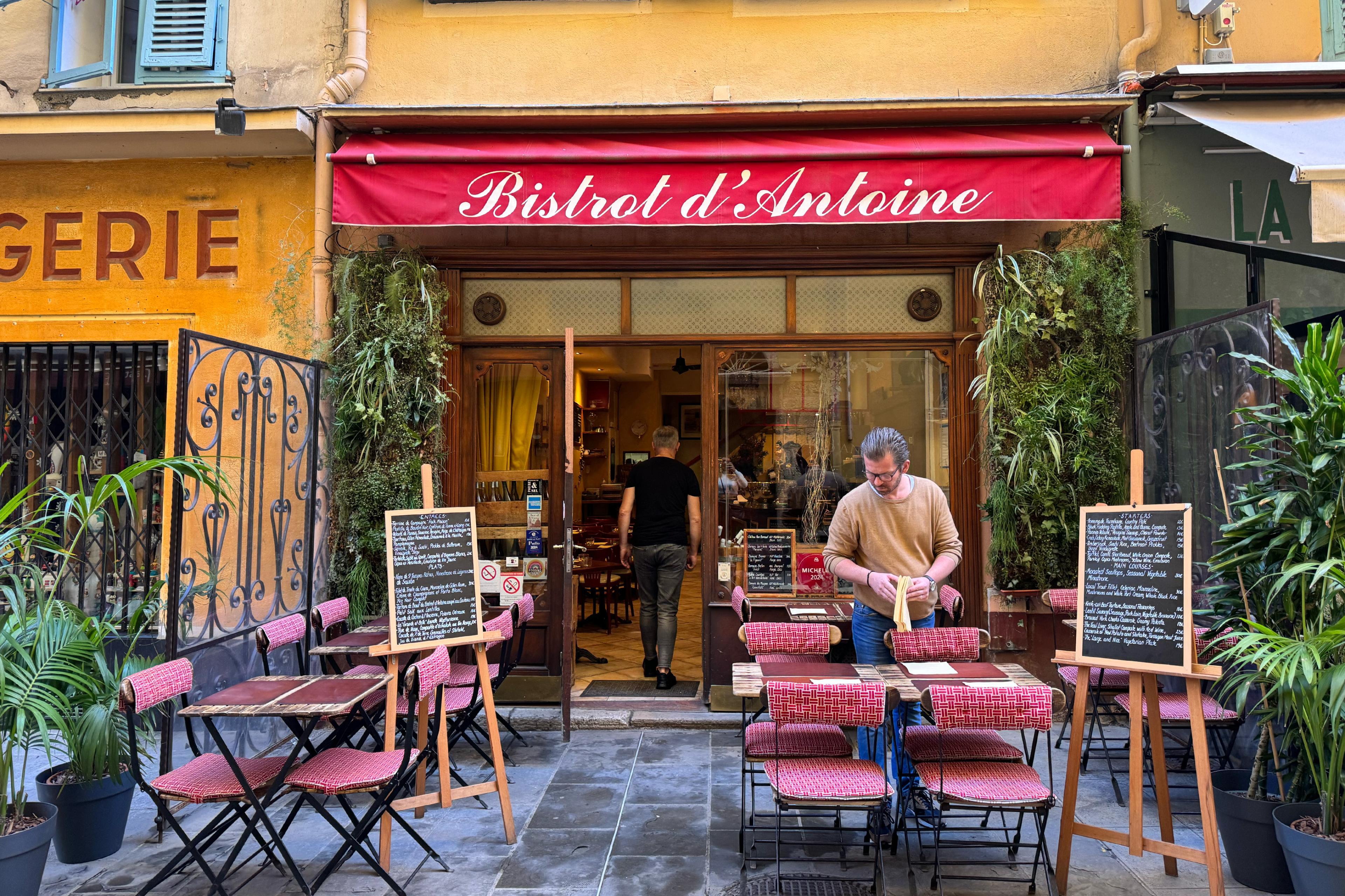 bistro with a red awning and outdoor tables
