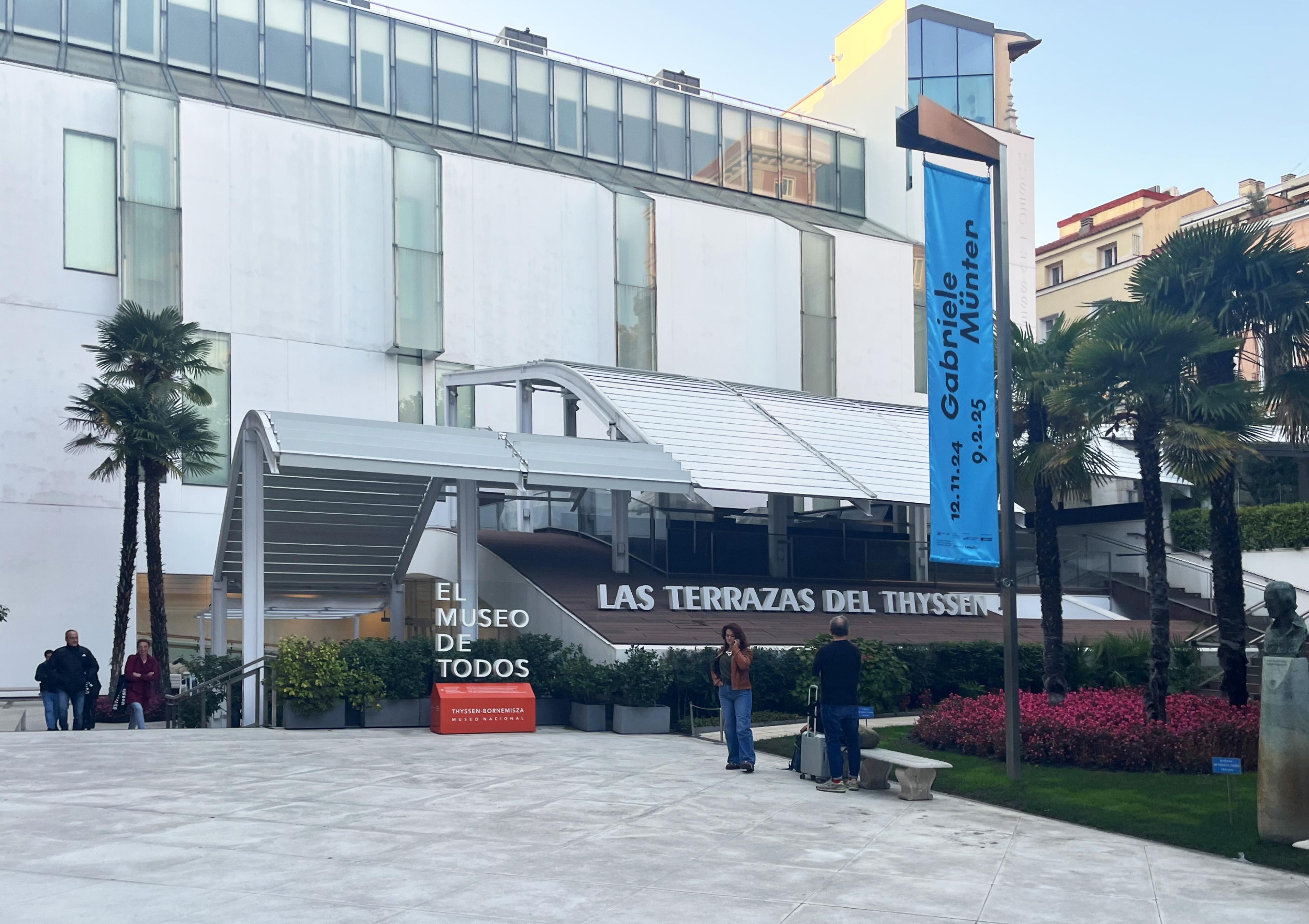 exterior of metalic museum building with plaza in front