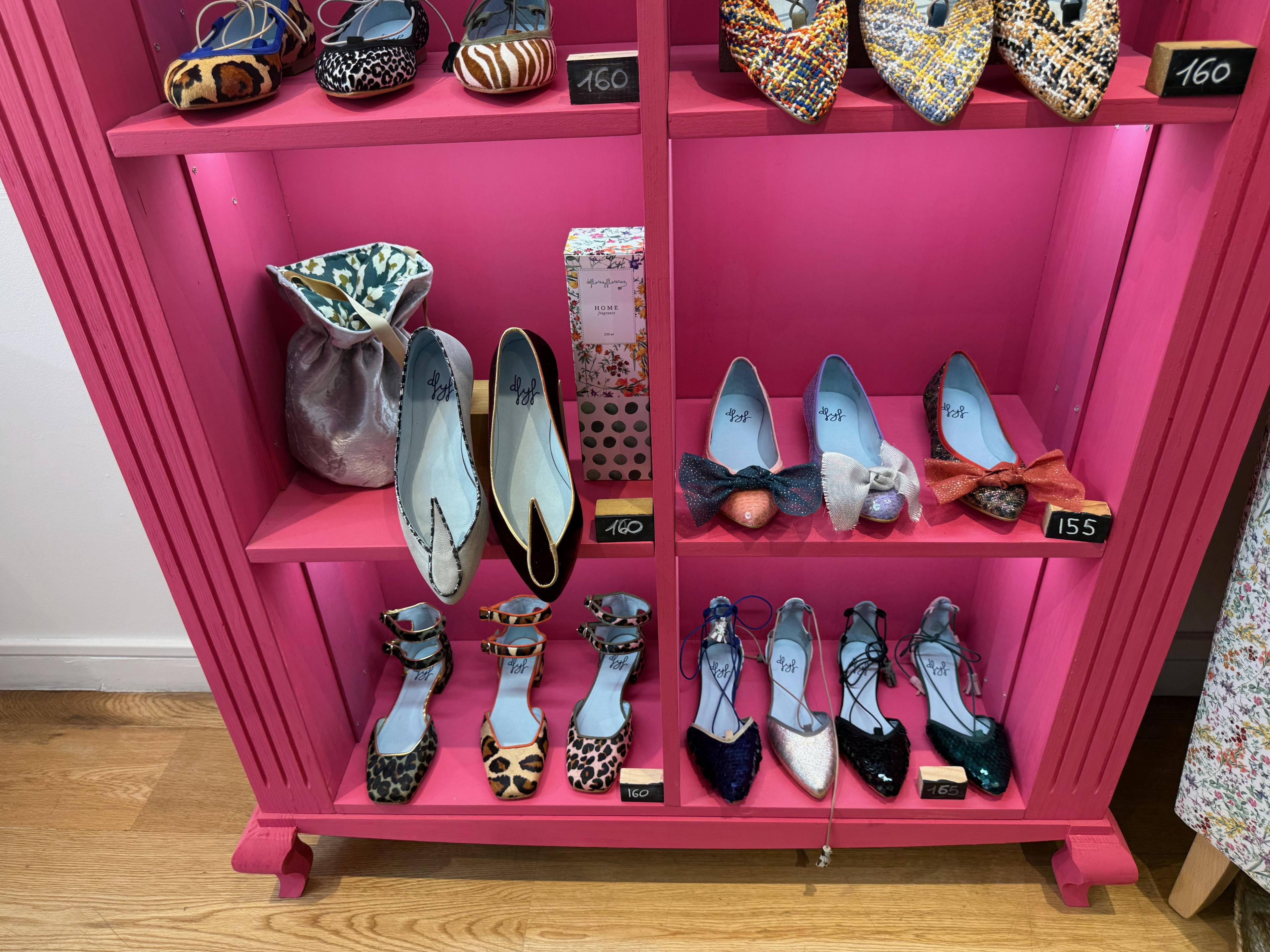 pink shelf full of unique shoes