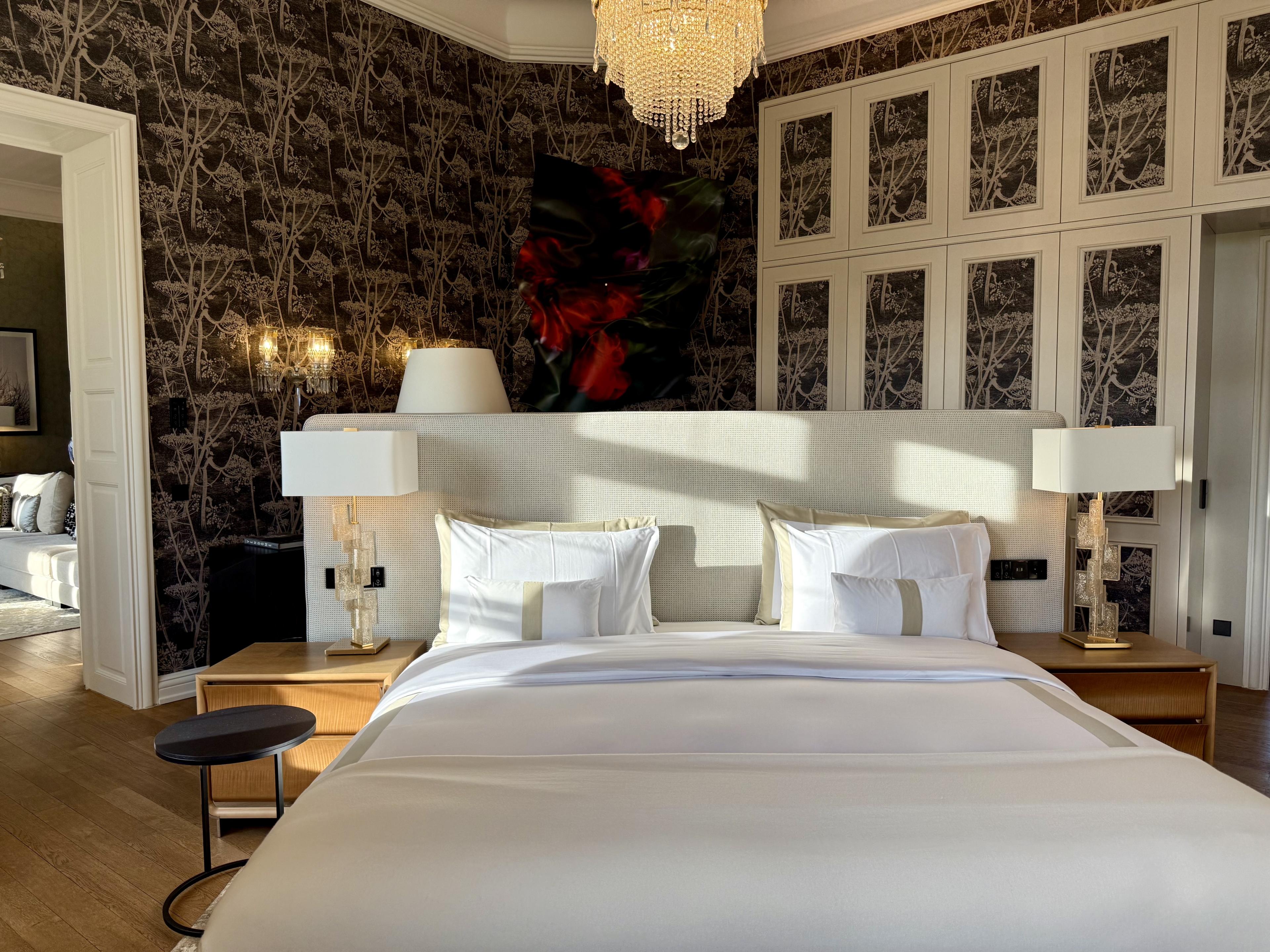 hotel bedroom with dark patterned wallpaper