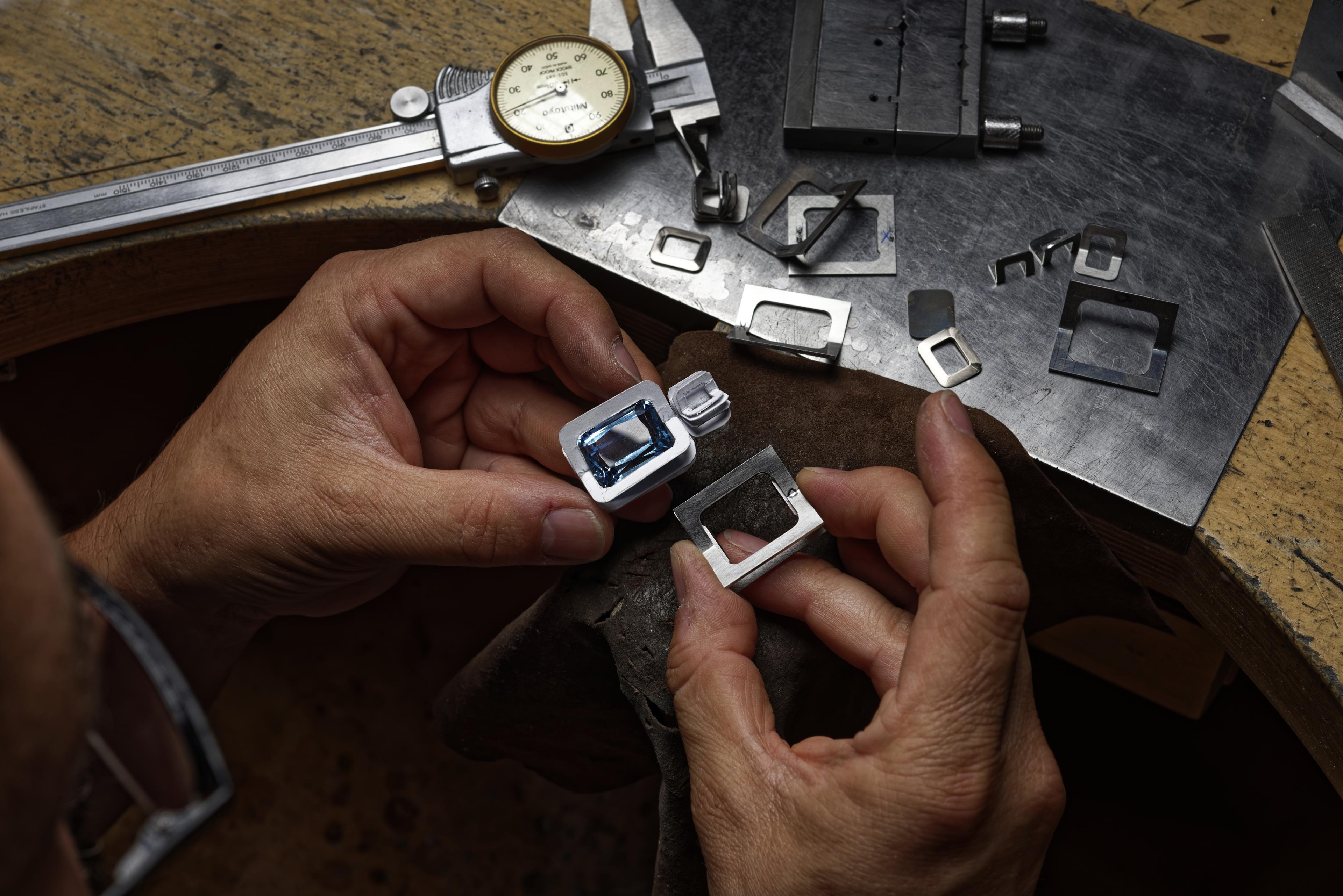 jeweler piecing together a piece of jewelry in an atelier