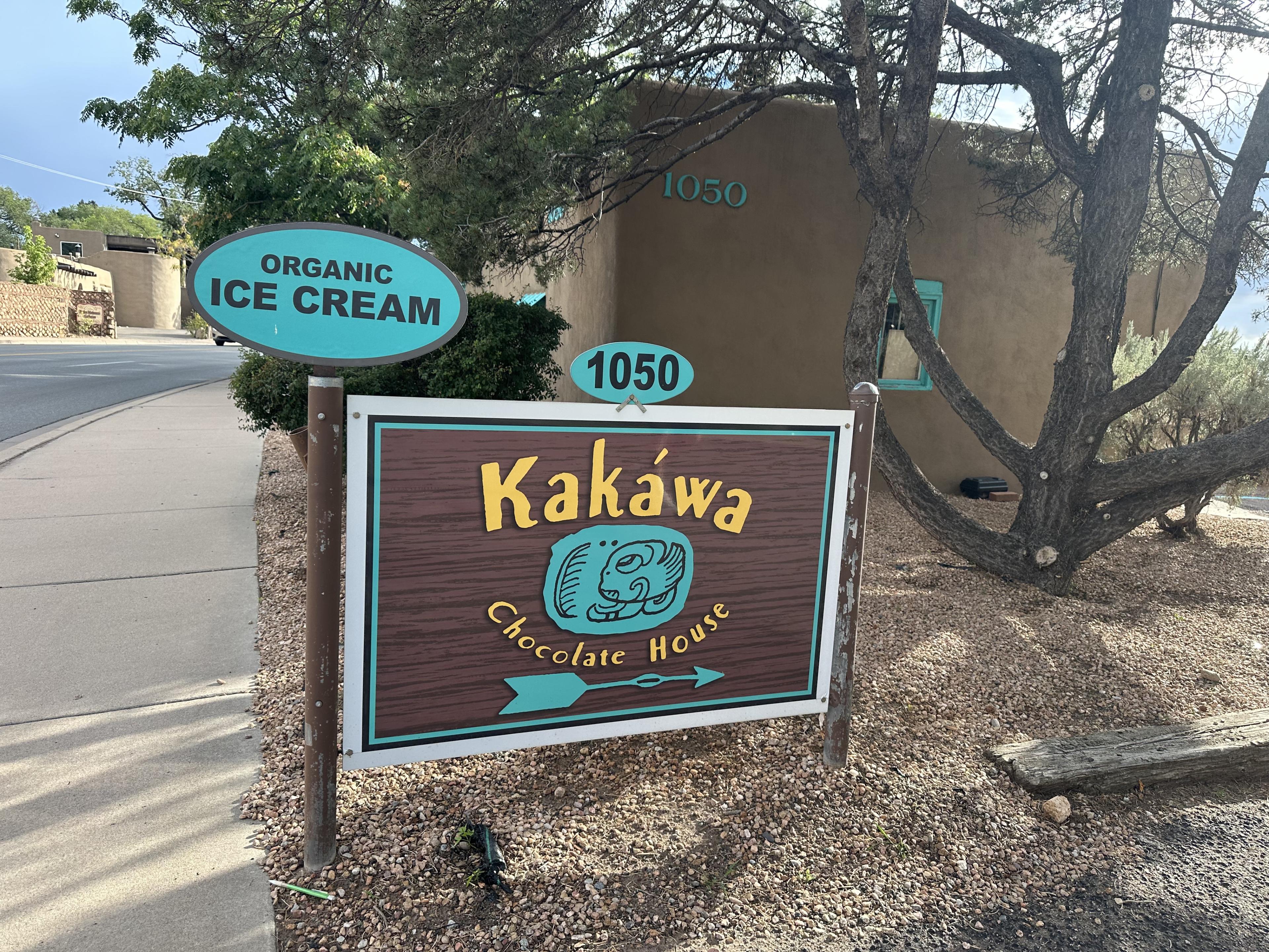 wood sign with yellow writing and aquamarine accents 