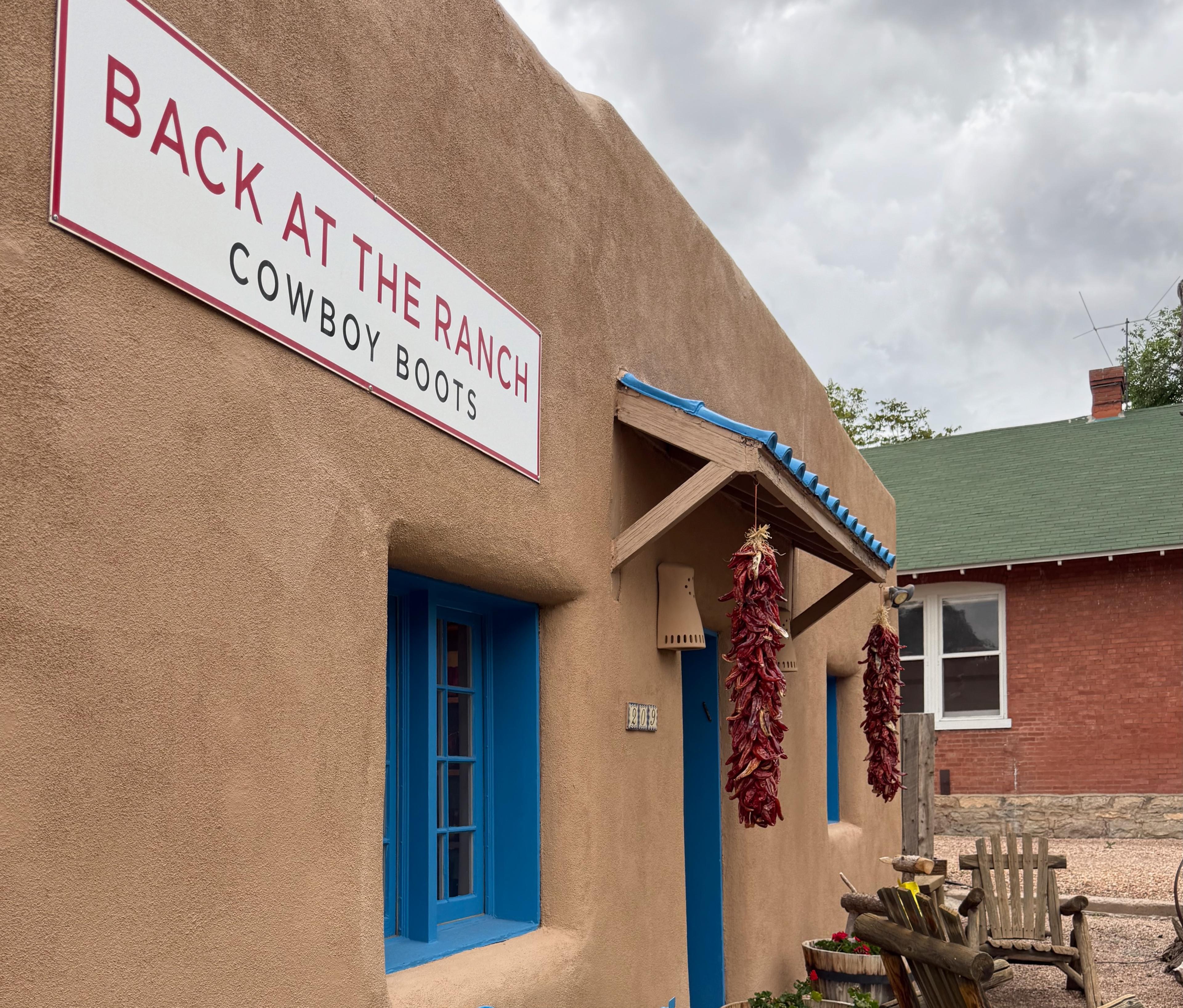 tan, adobe style building with bright blue door and window