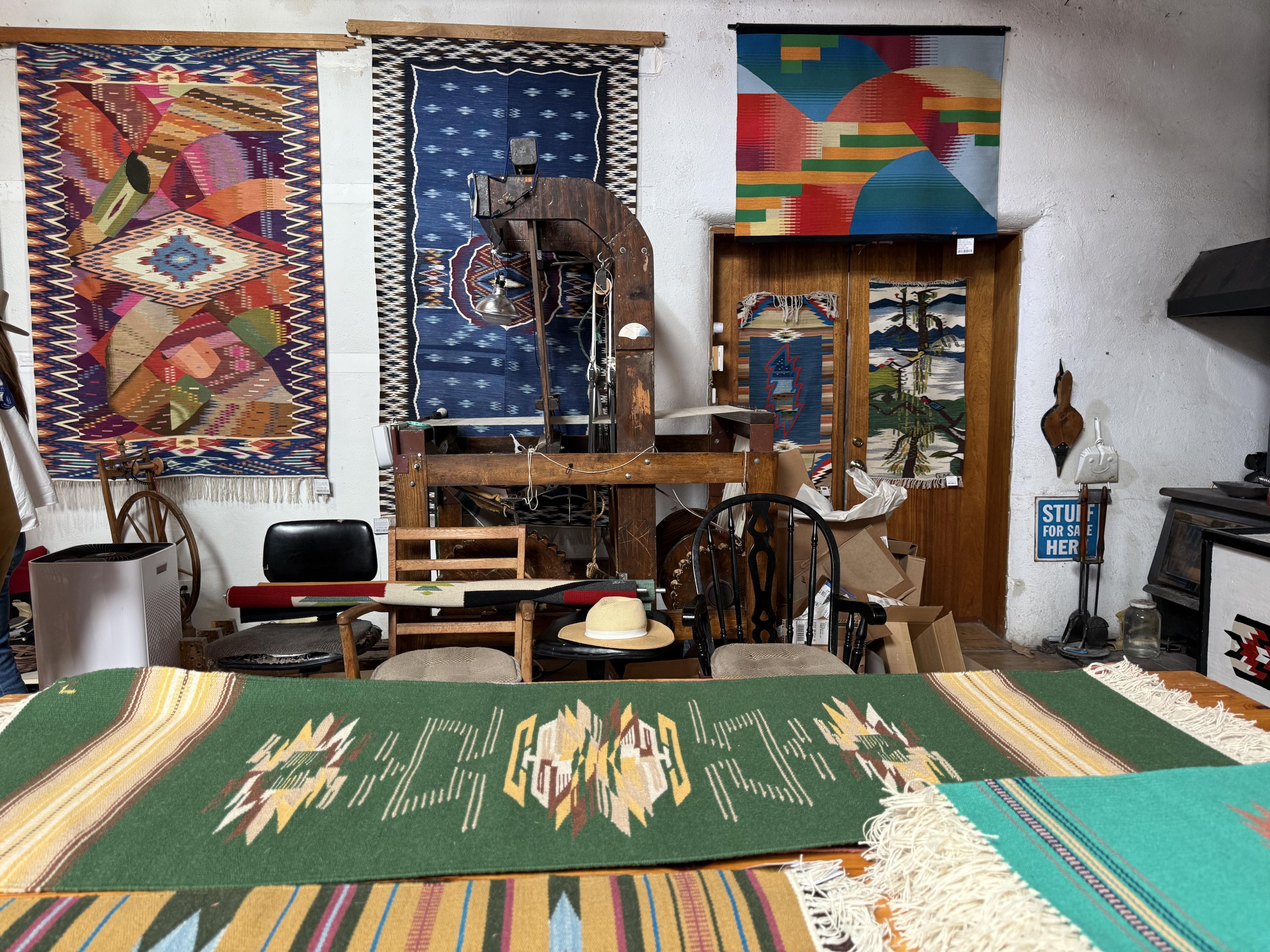 a weaving workshop with rugs and tapestries on display
